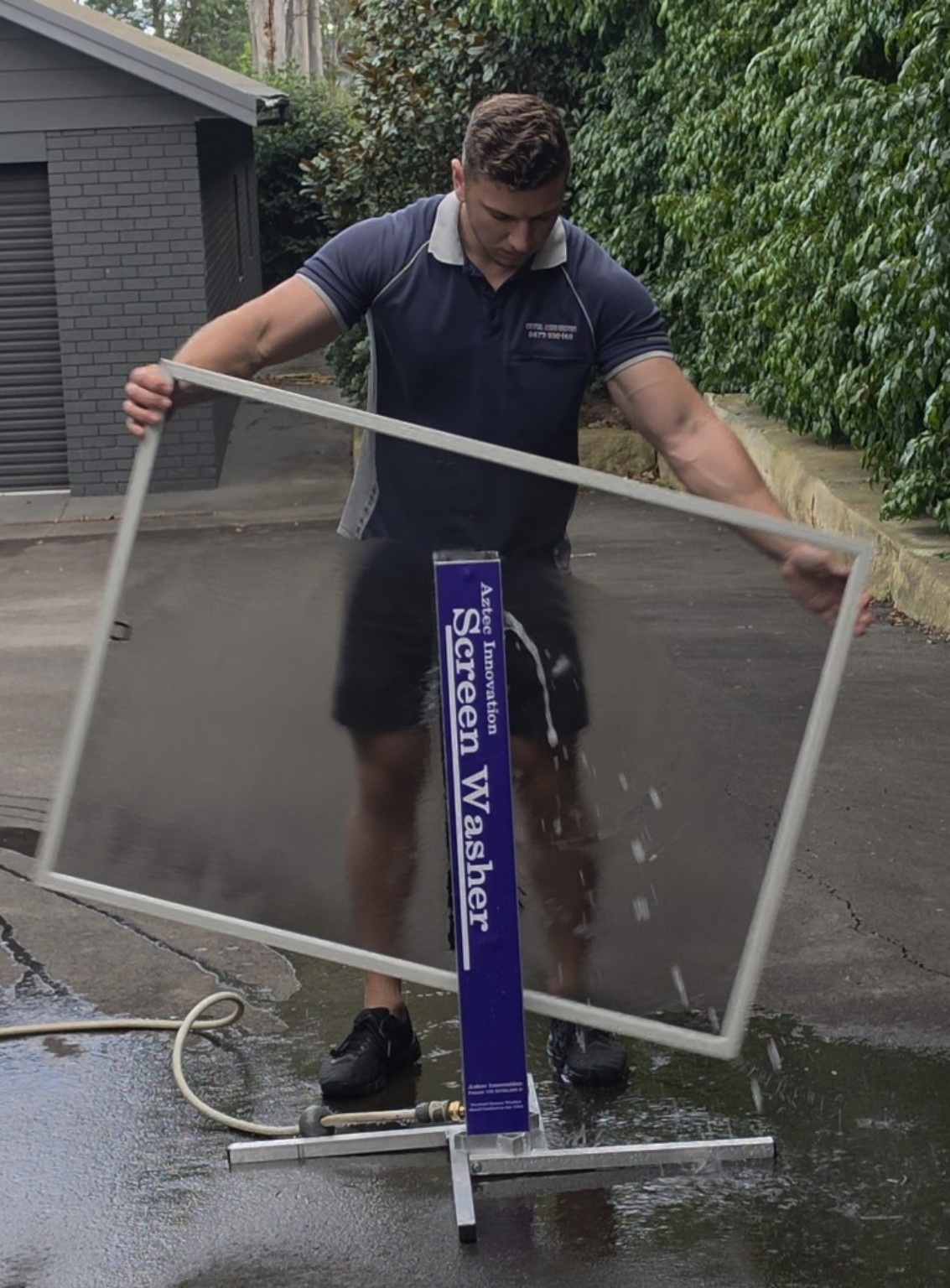 Crystal Clean Windows professional cleaning a fly screen with a screen washer